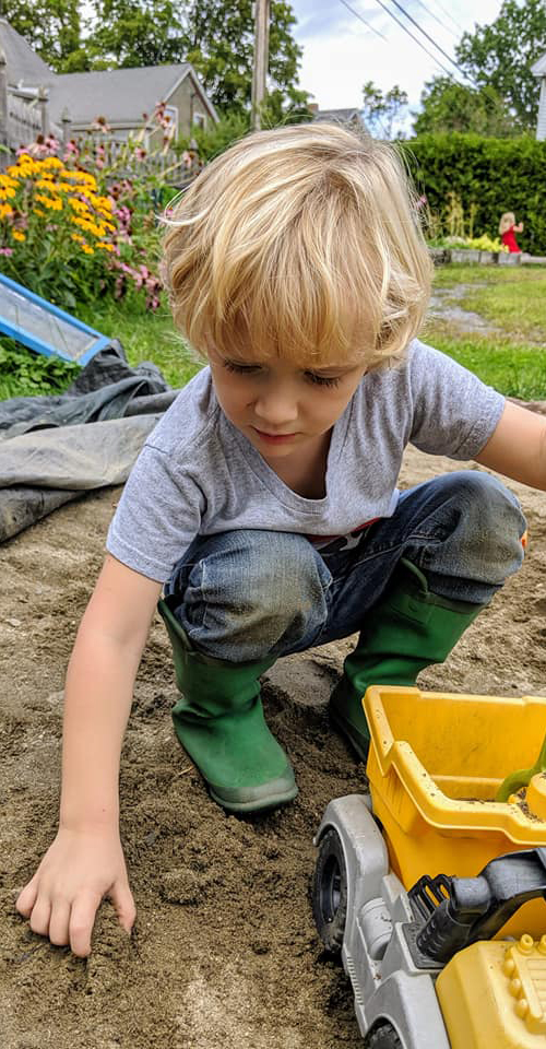 Boy Playing In Sandbox